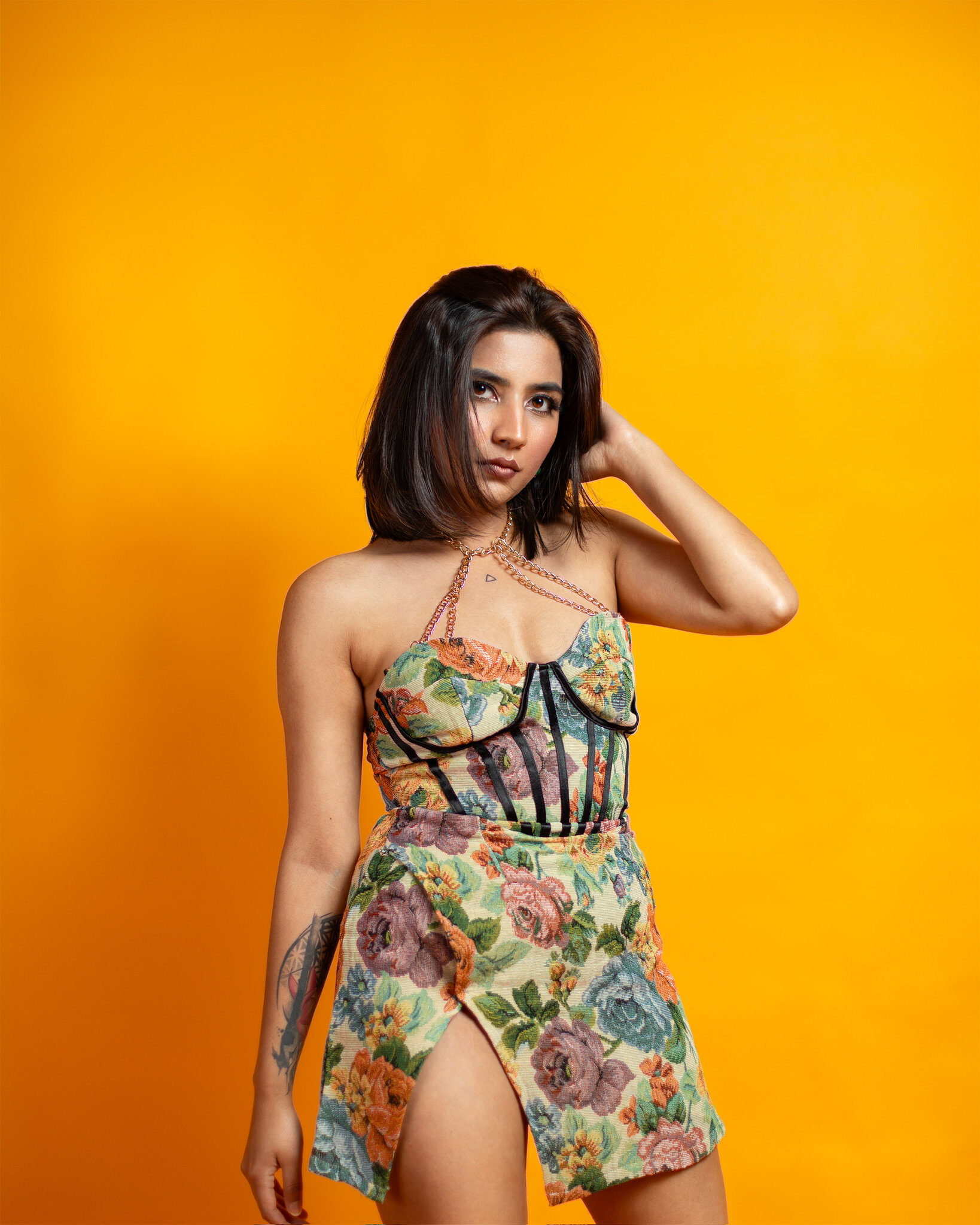 Studio portrait — yellow backdrop floral dress