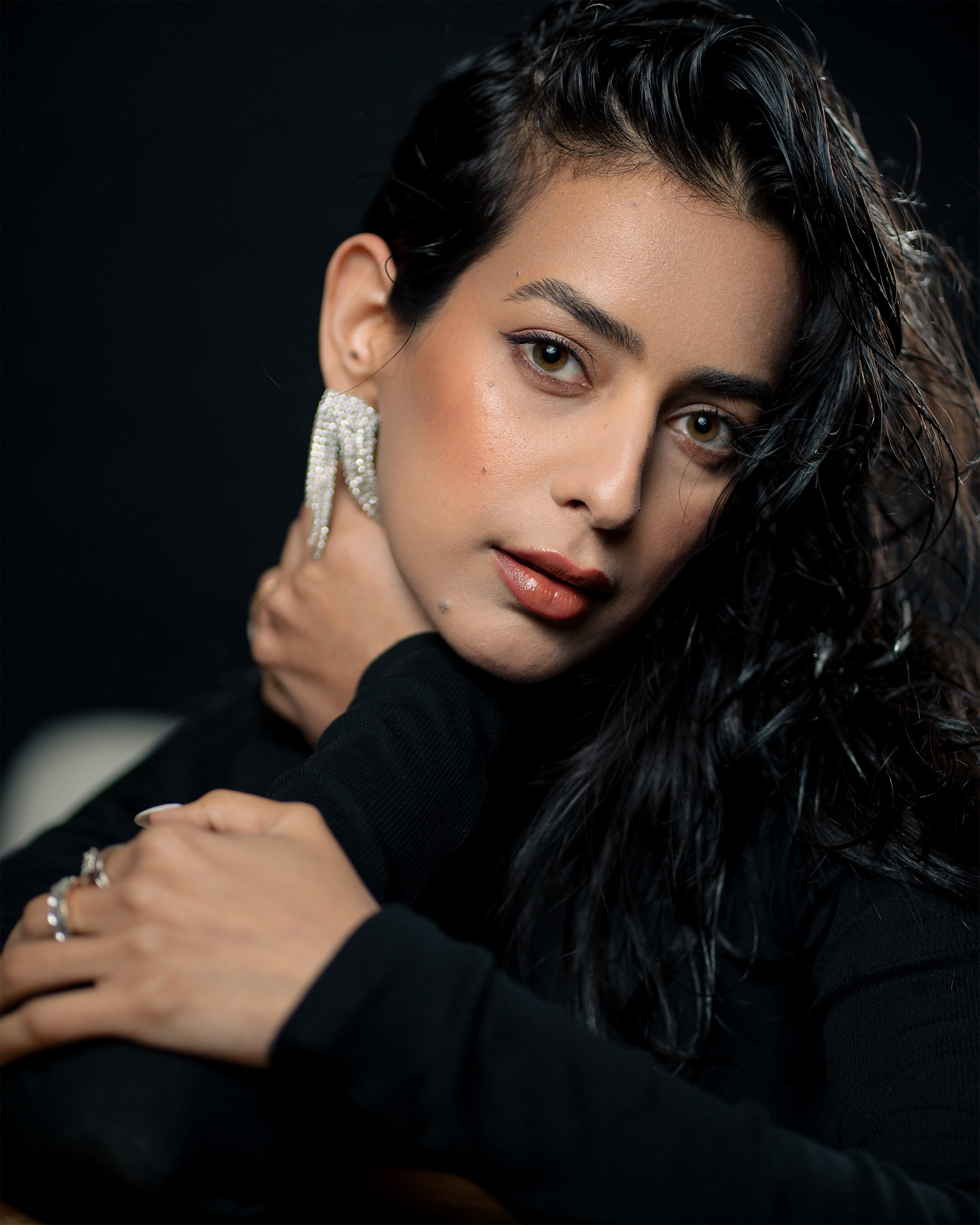 Editorial portrait — dark backdrop pearl earring