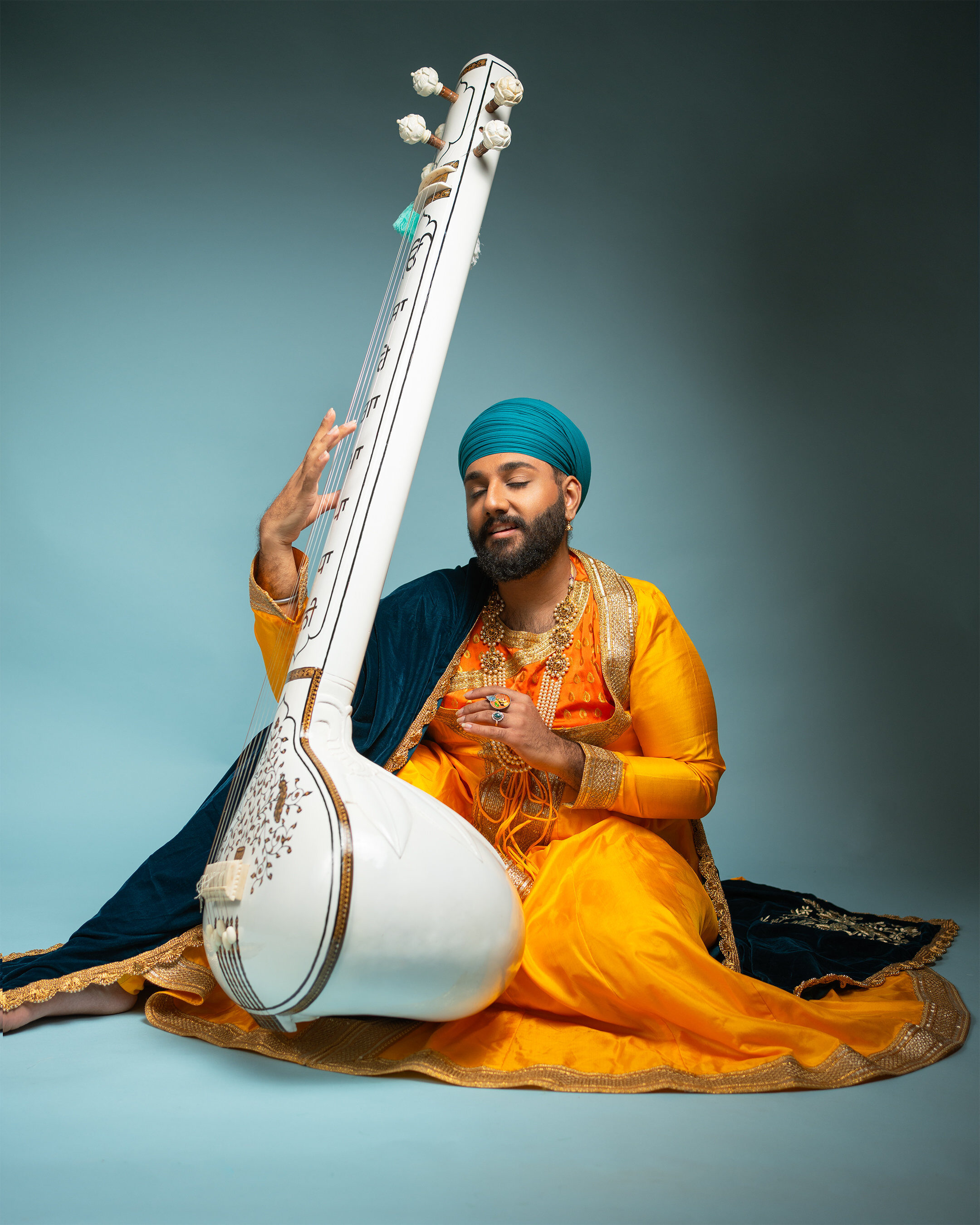 Cultural portrait — musician playing Taus instrument