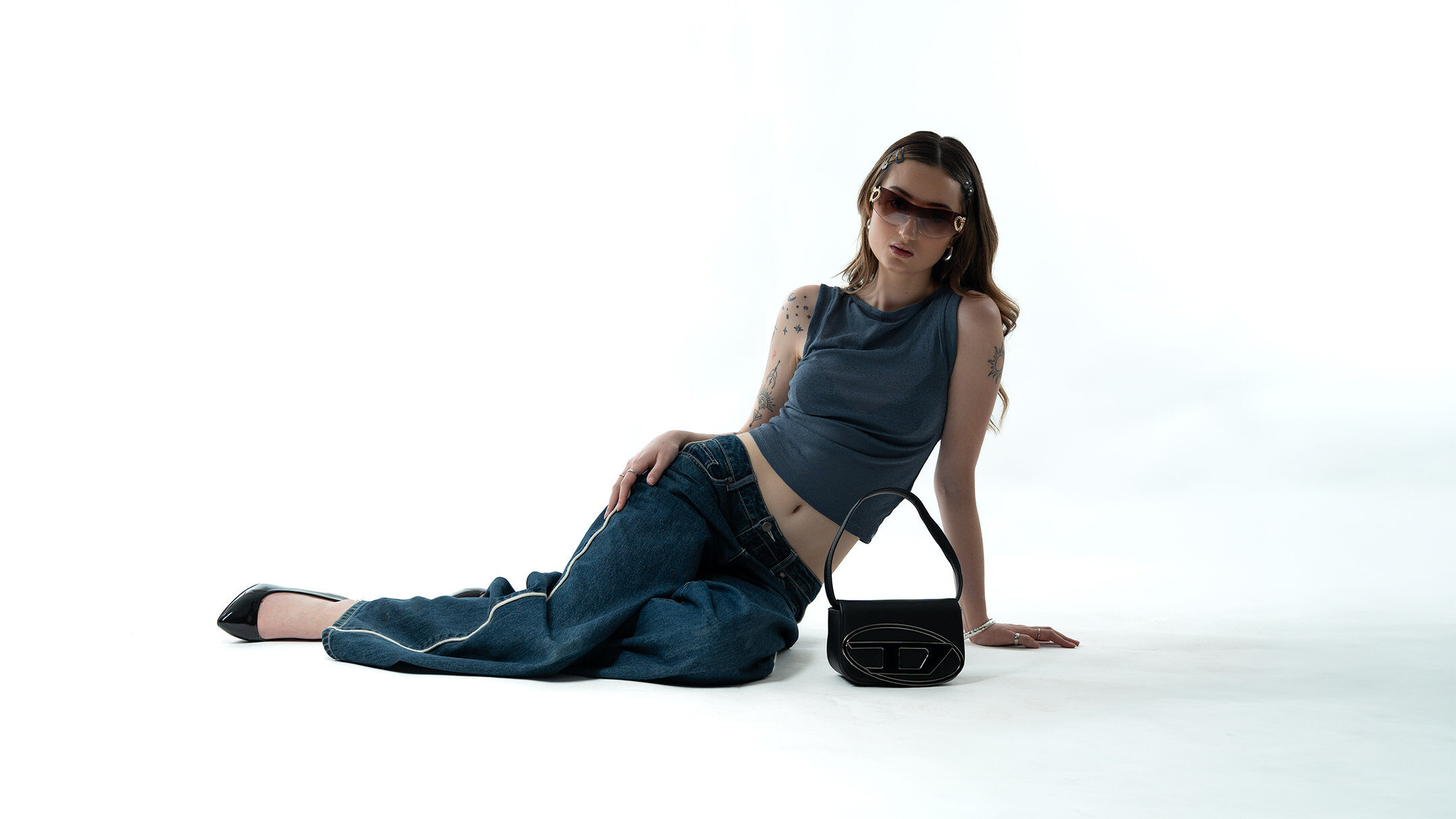 Fashion editorial — reclining with designer bag