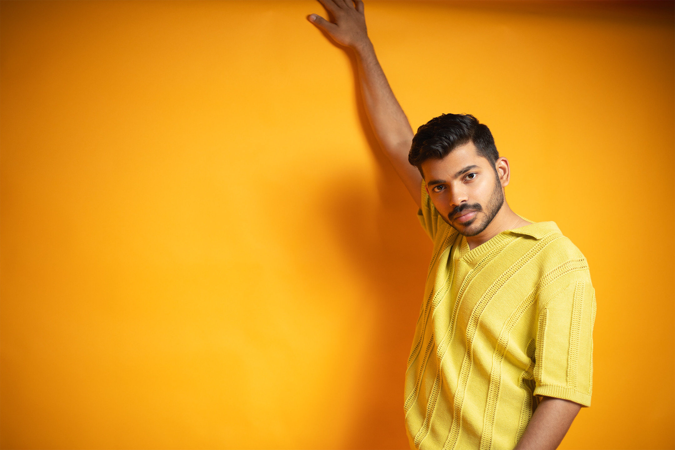 Male studio portrait — yellow backdrop