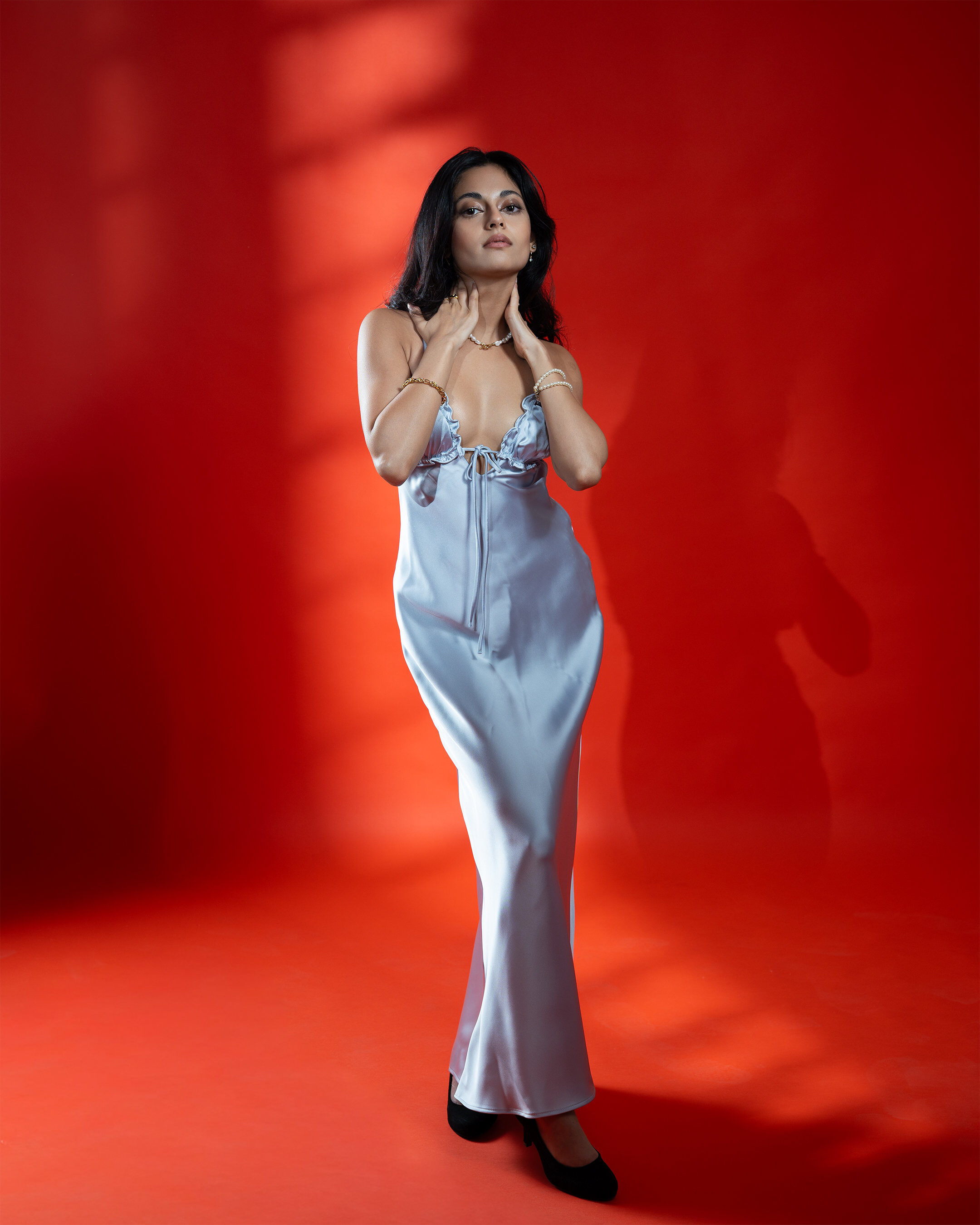 Full length studio portrait — blue on red