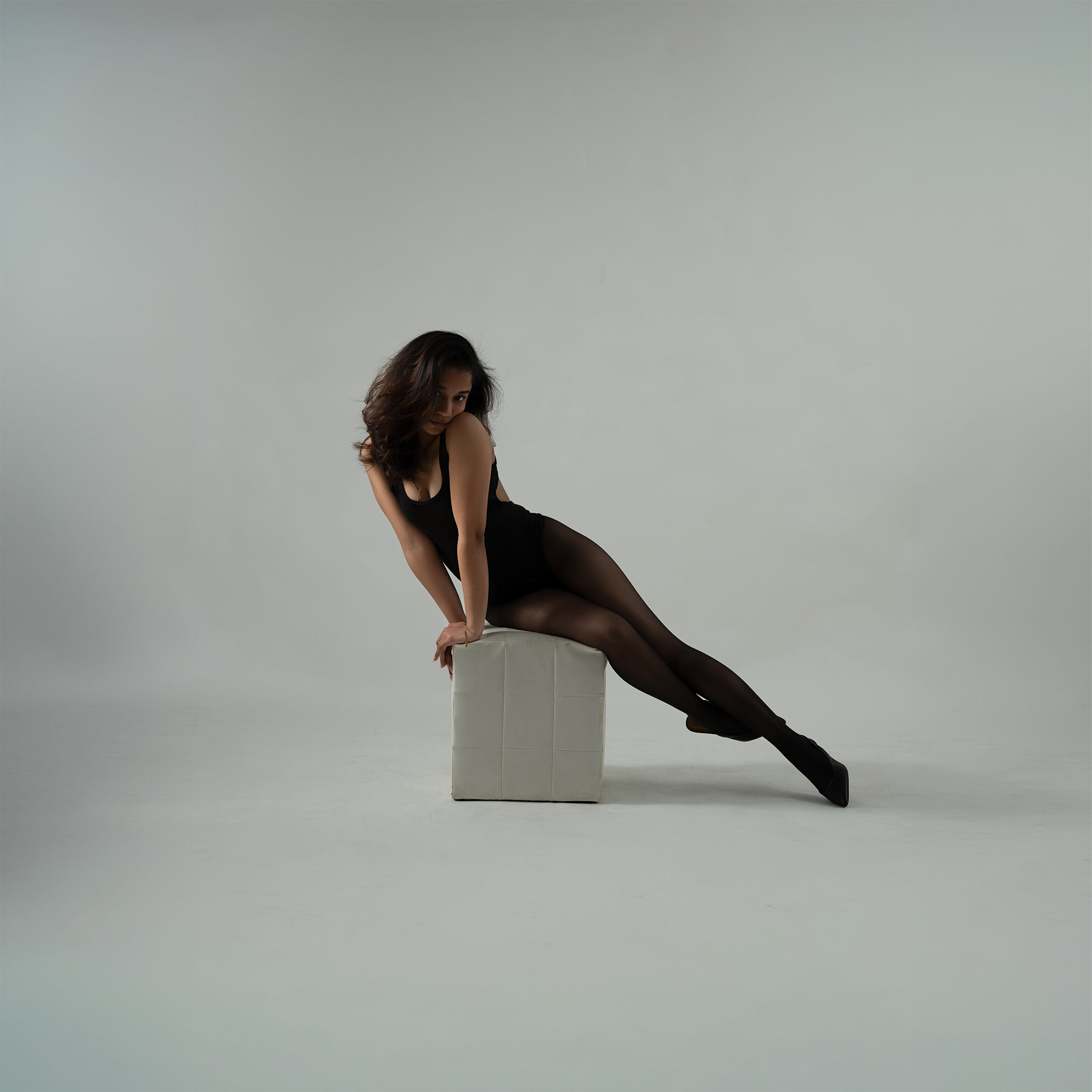 Studio portrait — dynamic lean grey backdrop