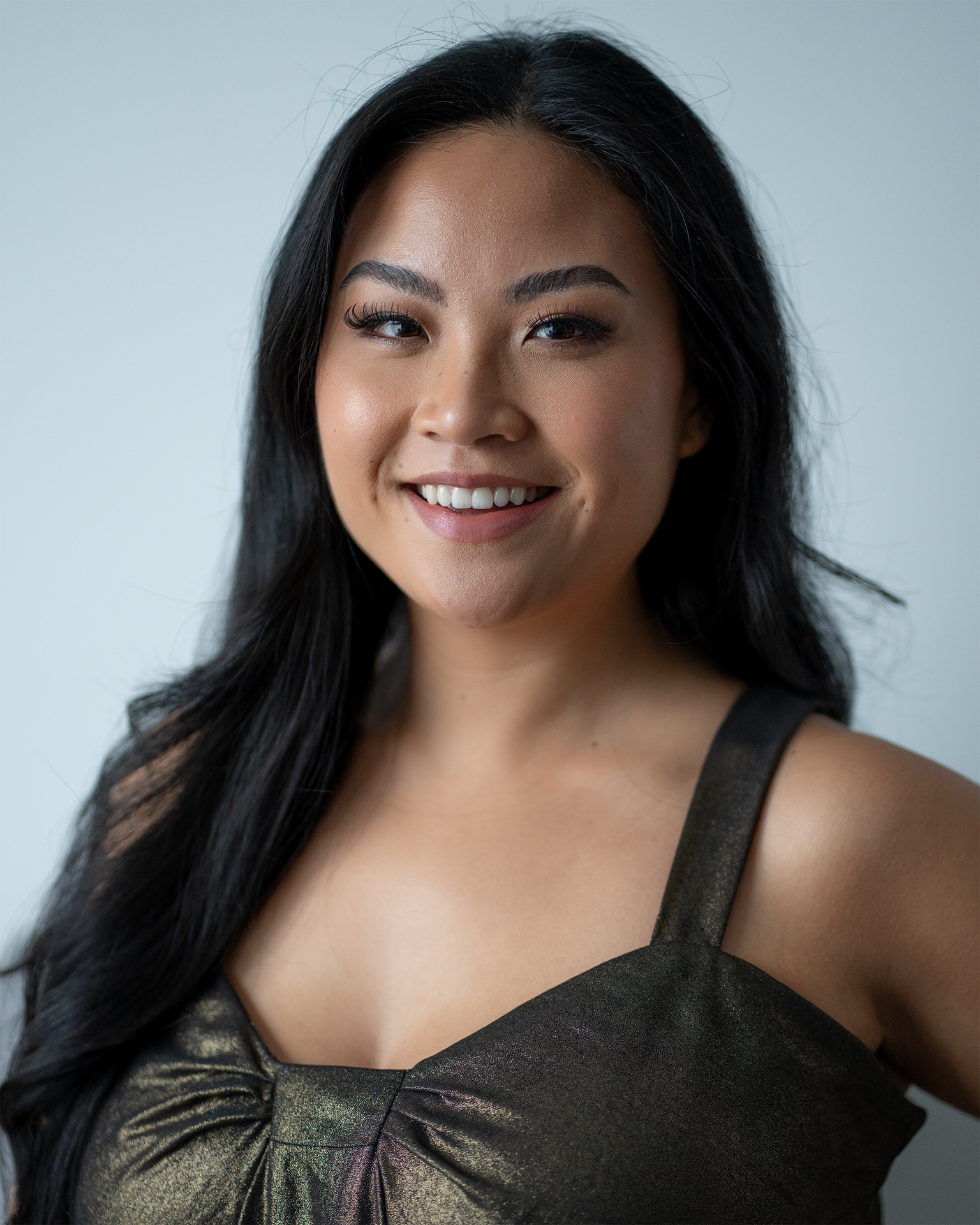 Model headshot — smiling metallic dress