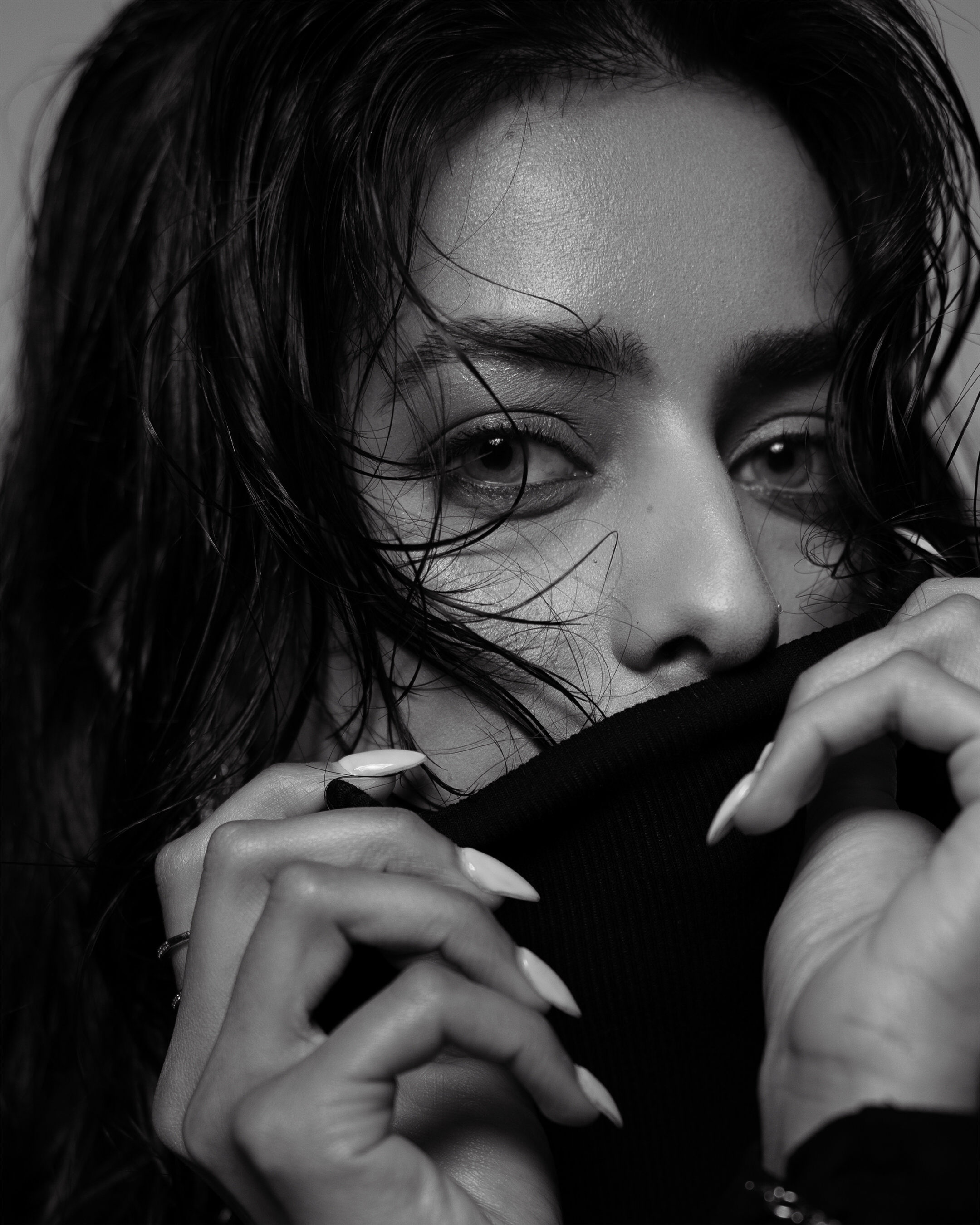 Dramatic B&W close-up — eyes and hands