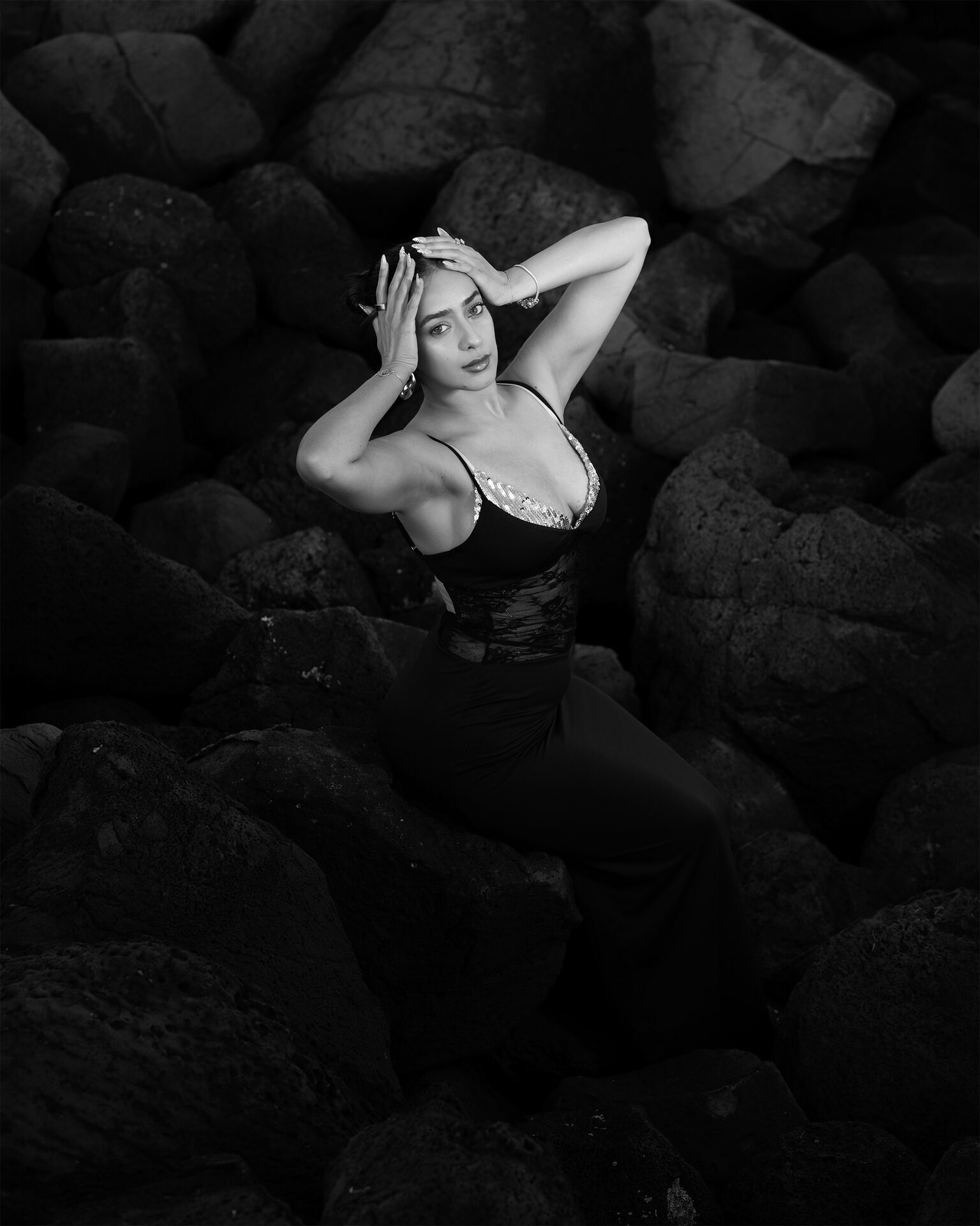 Outdoor editorial B&W — coastal rocks portrait