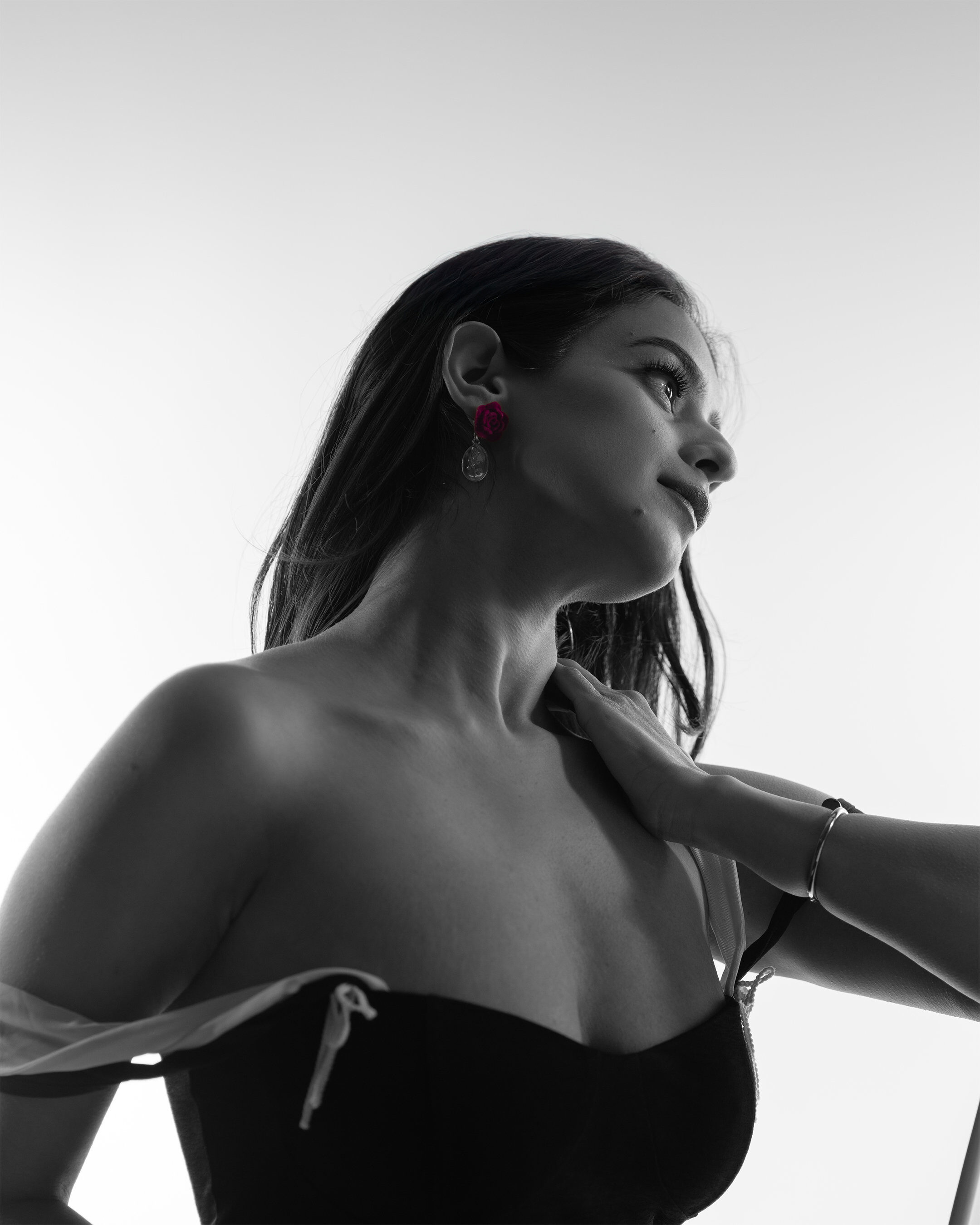 Editorial B&W — low angle portrait with rose earring