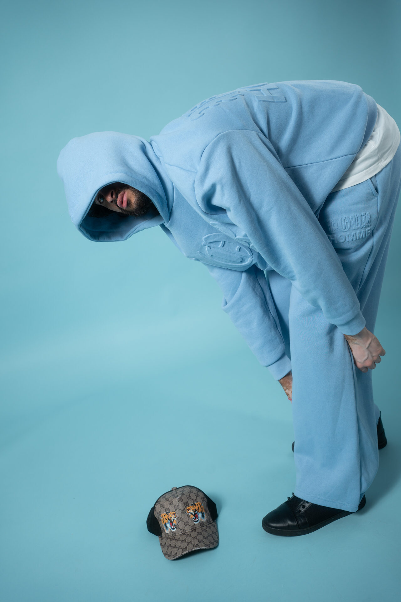 Shivi B — blue hoodie dynamic editorial pose